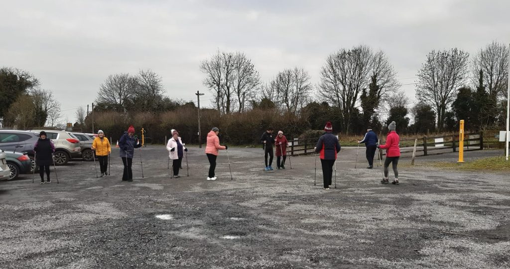 Older adults taking part in an outdoor Activator Poles class